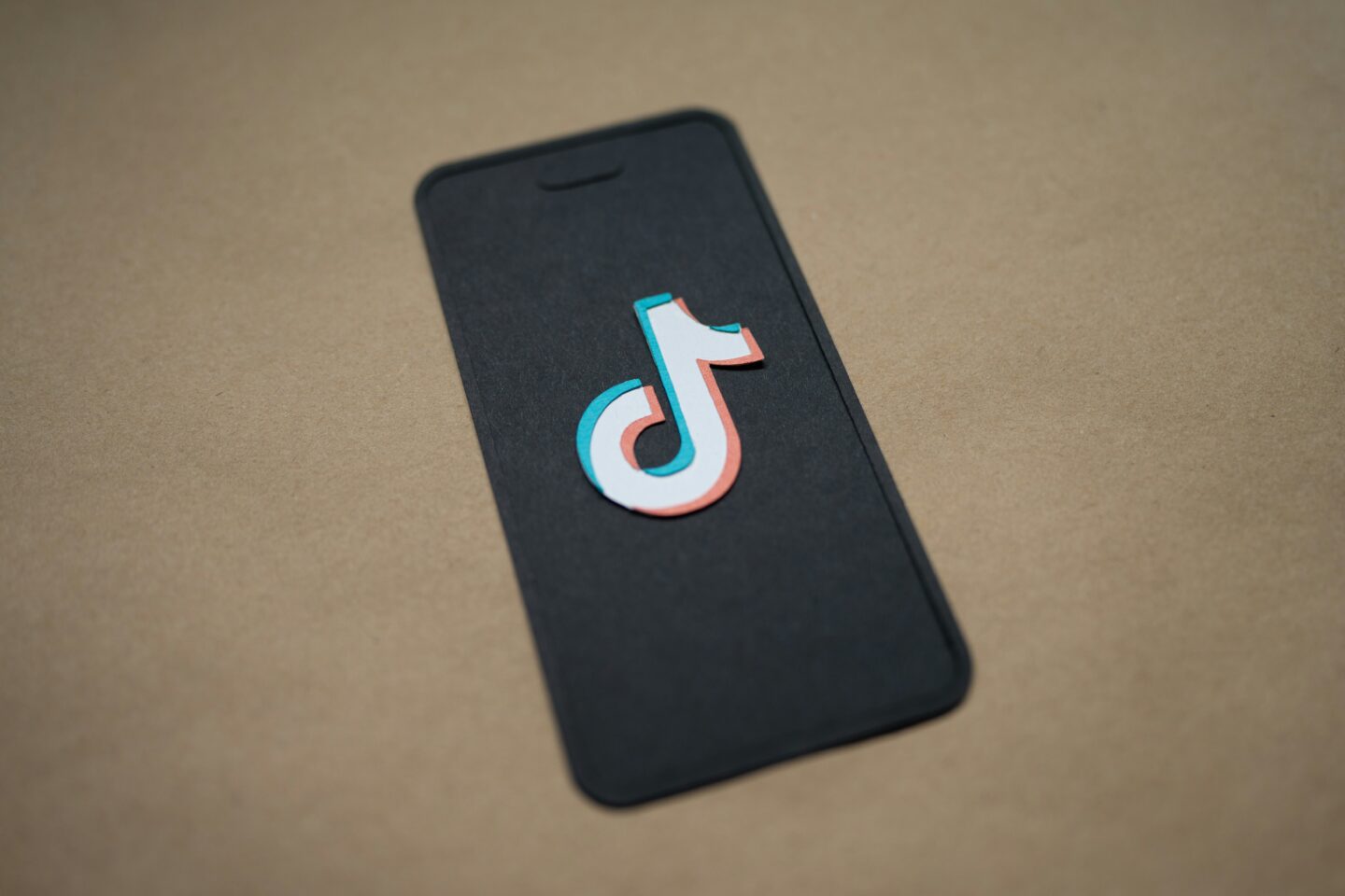 A depiction of a smart phone bearing the TikTok symbol.