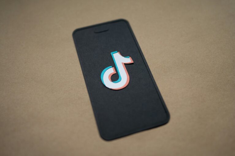 A depiction of a smart phone bearing the TikTok symbol.