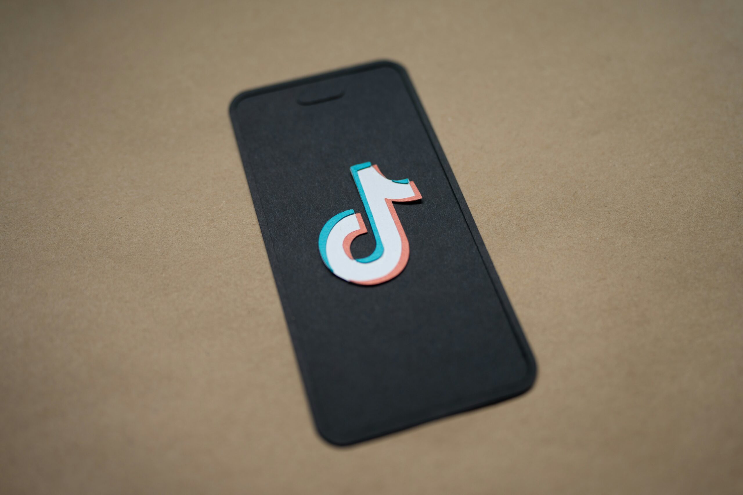 A depiction of a smart phone bearing the TikTok symbol.