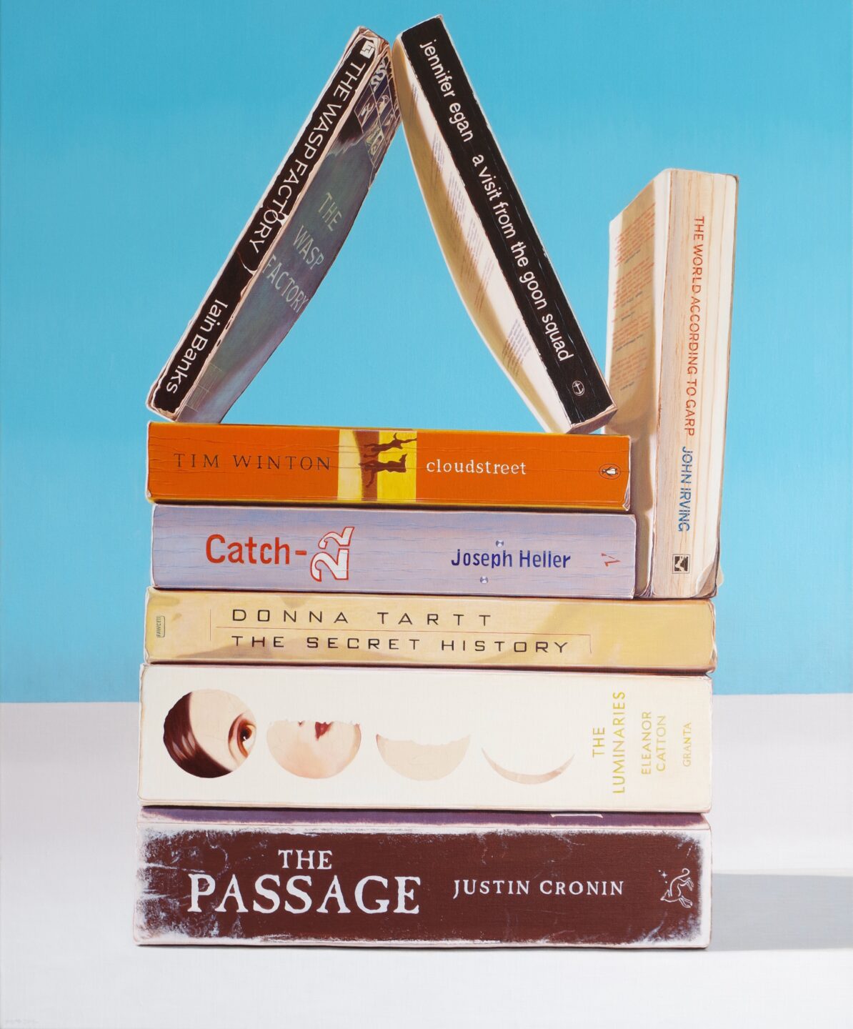 A life-like painting featuring number of books stacked and fashioned into the shape of a house.