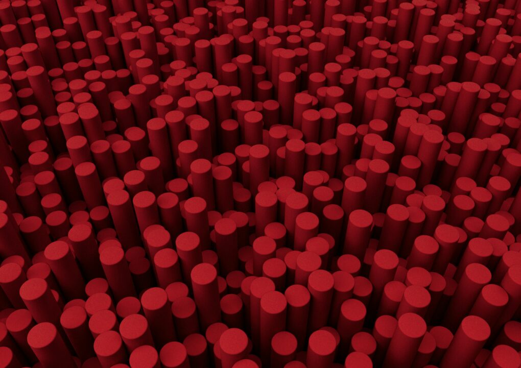 A large number of small red cylinders shot from above. The cylinders resemble cherry chapsticks.
