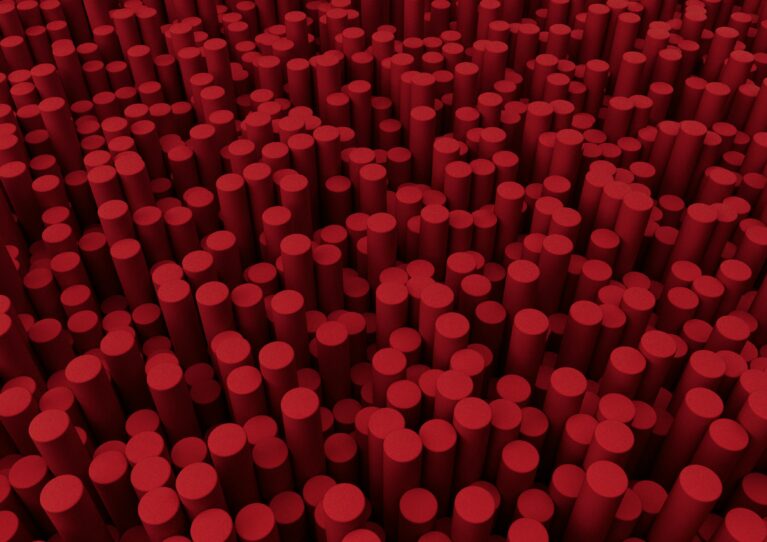 A large number of small red cylinders shot from above. The cylinders resemble cherry chapsticks.