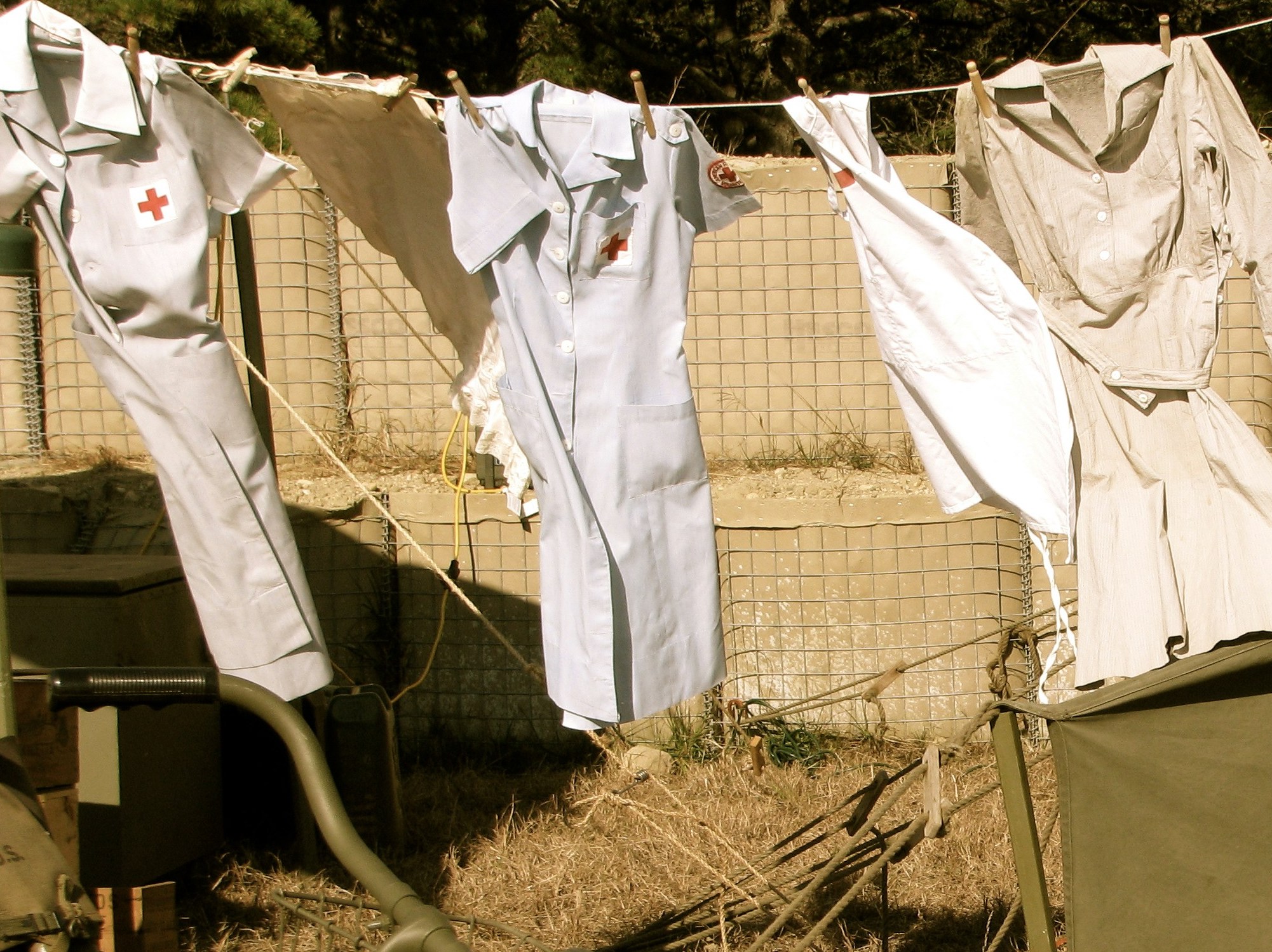 Nursing uniforms are hung up on a line to dry.