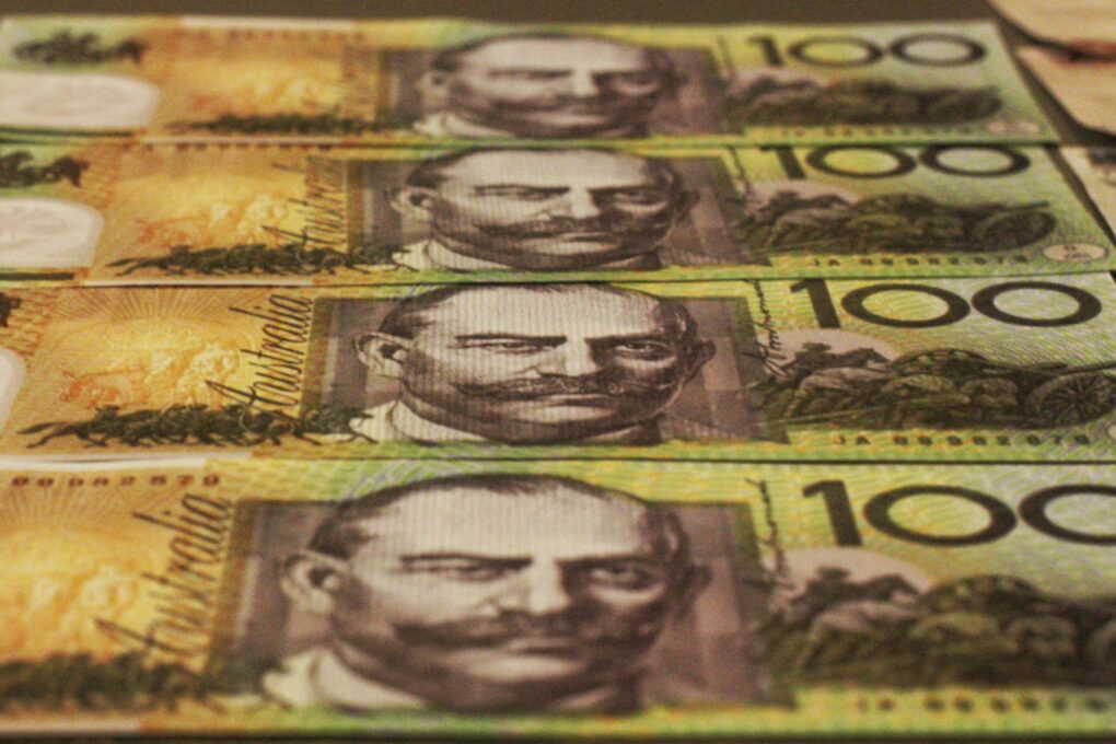 A close-up image of stacks of $100 notes.
