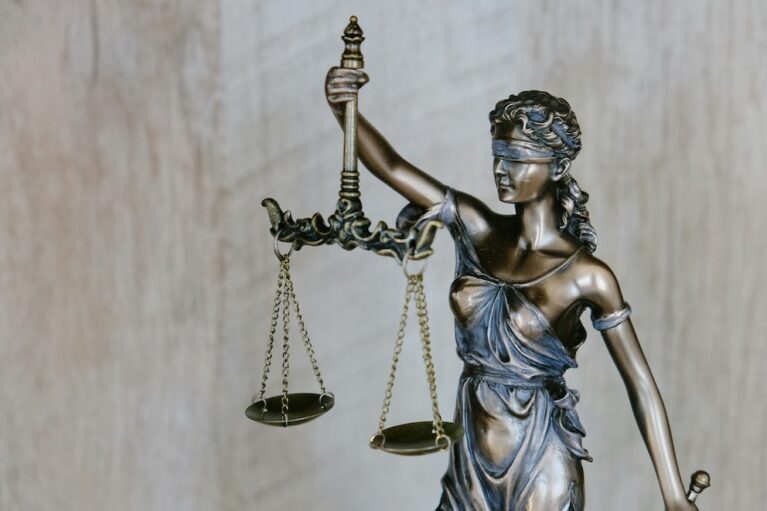 A statue of Lady Justice. She is blindfolded and holding a set of scales.