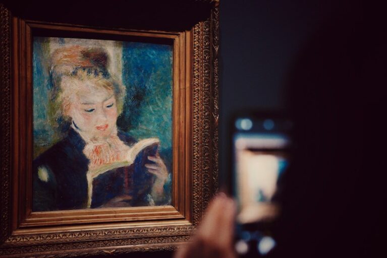 A picture of someone with a smartphone taking a picture of a classic portrait depicting a woman reading.