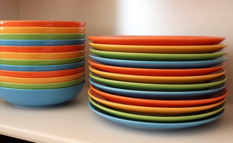 A stack of coloured plates and bowls.