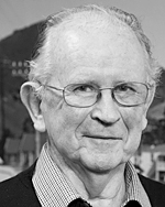 Vincent O'Sullivan the newly appointed Poet Laureate  pictured in front of a photograph by Gladys M Goodall showing  Havelock, Marlborough Sounds,ca 1960s, GG-10-0128. PHOTO: Mark Beatty